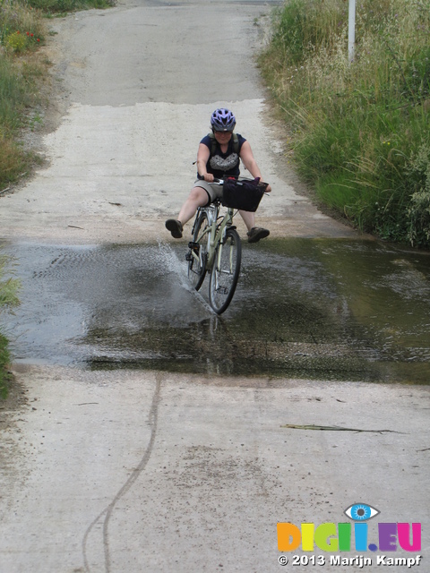 SX27585 Jenni cycling through stream